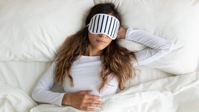 woman sleeping with an eye mask
