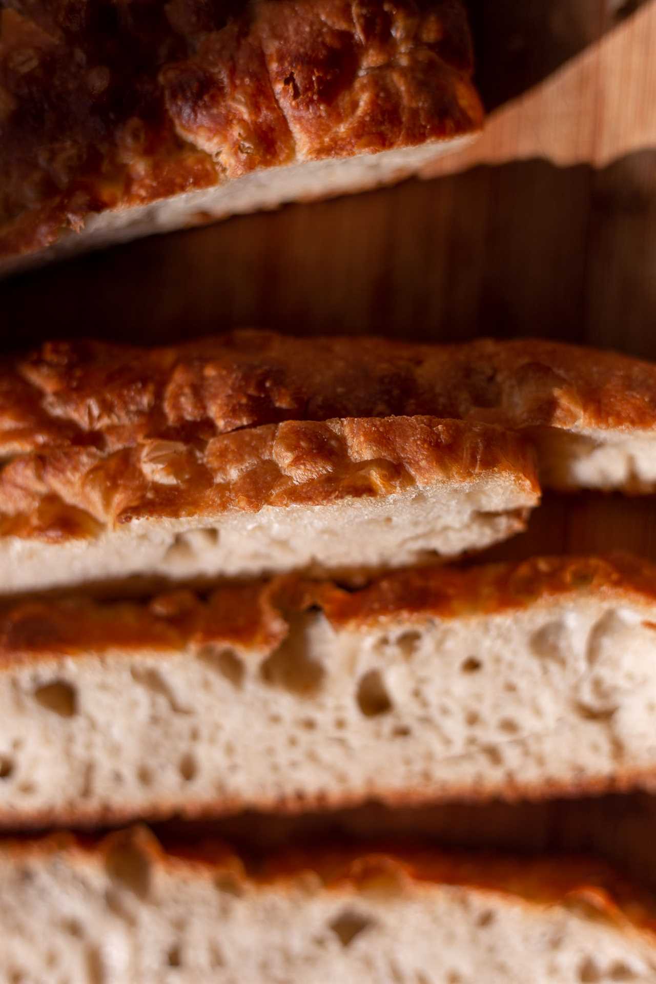 close up view of dimpled sourdough focaccia bread golden brown crust