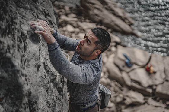 Man climbing and scaling a mountain