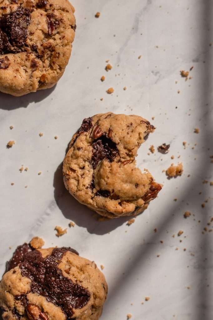 a sourdough chocolate chip cookie with a bite taken out of it