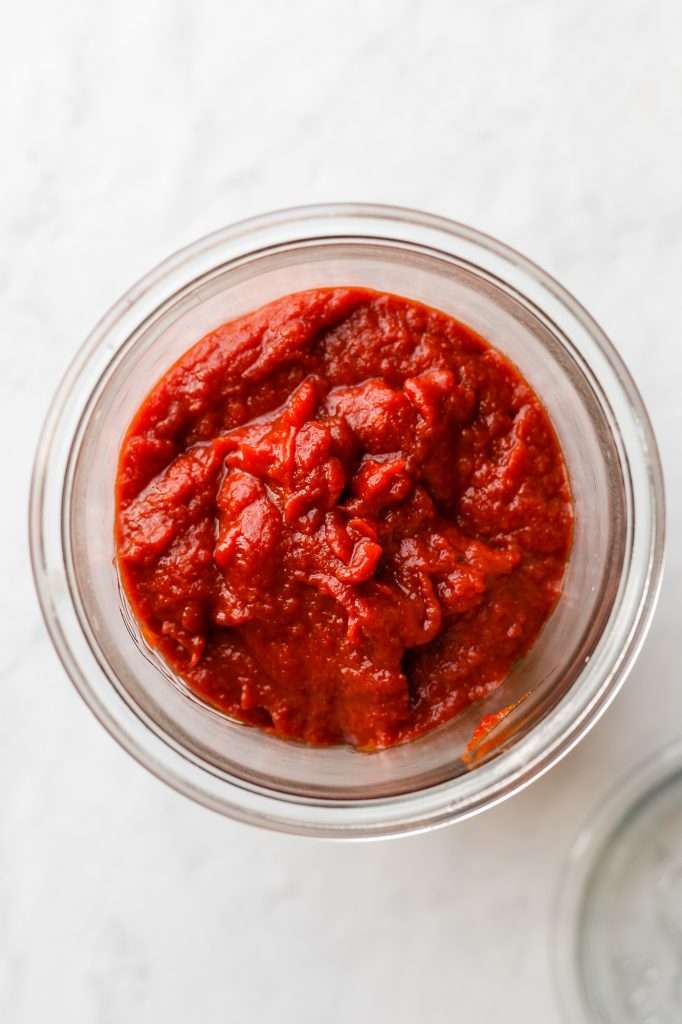 rich, red fermented ketchup in a glass jar. 
