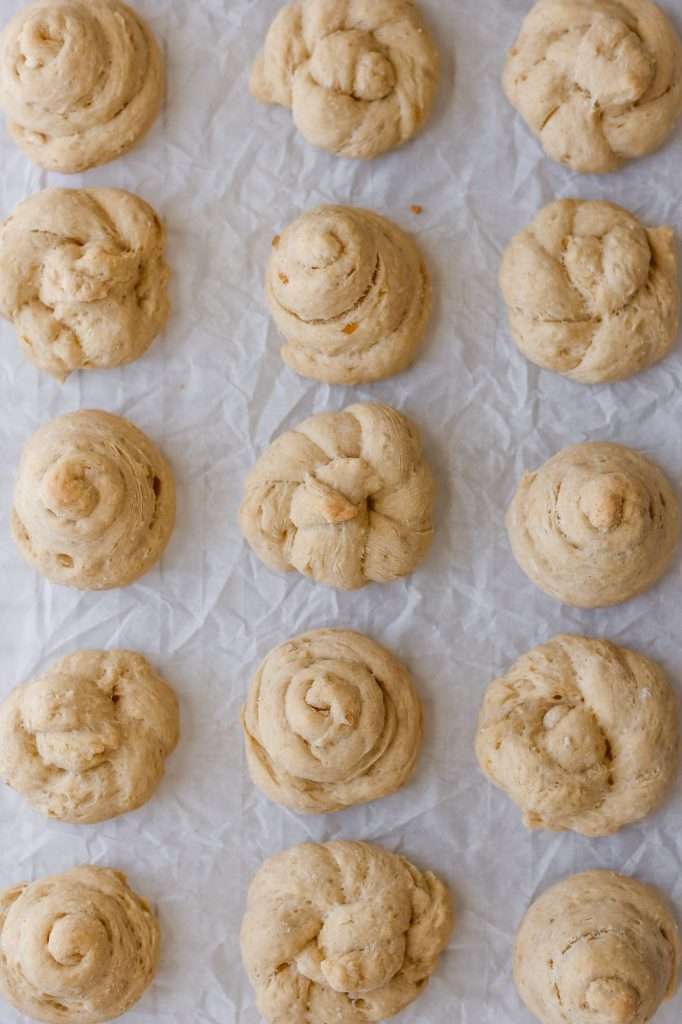 freshly baked sourdough discard Italian Easter cookies on crinkly white parchment paper. 